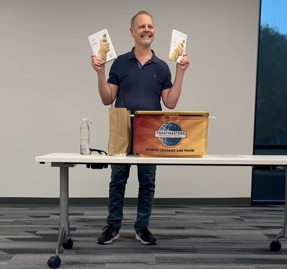 Richard Willett holding the hardcover and paperback editons of A Friend of Dorothy's